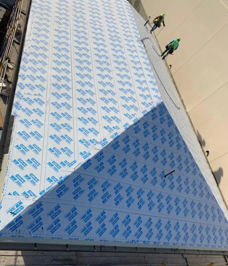 Professional roofers installing underlayment on a metal roof in Winfield